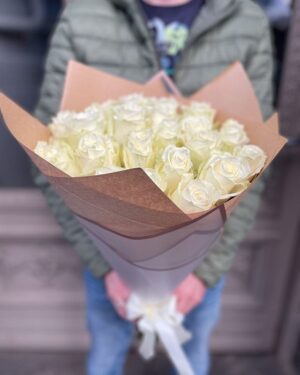 Baltu rožu pušķis dekoratīvā iepakojumā